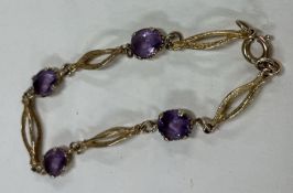 An attractive 9 carat and amethyst four stone bracelet.