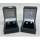 Two pairs of gold mounted pearl ear studs contained within a fitted box.