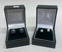 Two pairs of gold mounted pearl ear studs contained within a fitted box.