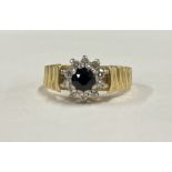 A sapphire and diamond circular cluster ring in 18 carat gold mount.