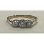 A good diamond three stone ring in 18 carat gold and platinum setting.