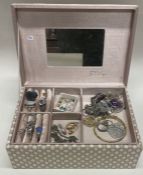A box containing silver rings, pendants etc.
