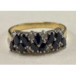 An 18 carat gold sapphire and diamond cluster ring in claw mount.