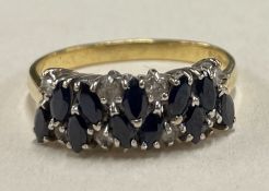 An 18 carat gold sapphire and diamond cluster ring in claw mount.