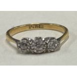 A diamond three stone ring in 18 carat gold and platinum mount.