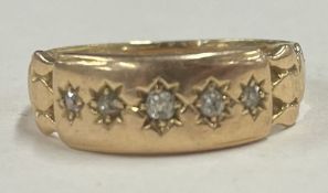 A small 18 carat gold and diamond five stone ring.