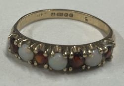 A garnet and opal half eternity ring in 9 carat setting.