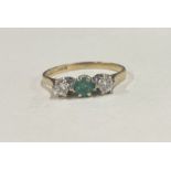 An emerald and diamond three stone ring in 9 carat claw mount.