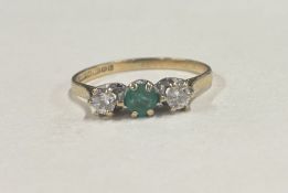 An emerald and diamond three stone ring in 9 carat claw mount.