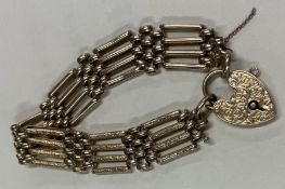 A good 9 carat gate bracelet with frosted links and chased padlock.