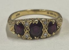 A good garnet and diamond half hoop ring in 18 carat gold setting.