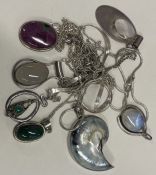 A large collection of heavy silver pendants etc.