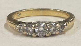 A diamond five stone ring in 18 carat gold setting.