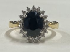 A good circular sapphire and diamond cluster ring in 18 carat gold claw mount.