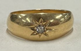 A small 18 carat gold diamond gypsy set ring.