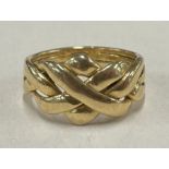 An unusual 18 carat gold knot ring of typical form.