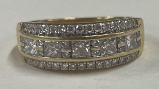 A small princess cut diamond three row ring in 18 carat gold setting.