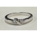 A small diamond crossover ring in 18 carat white gold setting.