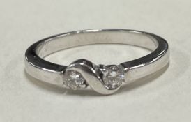 A small diamond crossover ring in 18 carat white gold setting.