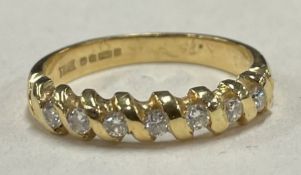 A good 18 carat gold and diamond seven stone half eternity ring.