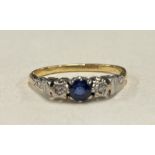 An attractive 18 carat gold sapphire and diamond three stone ring.