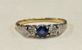 An attractive 18 carat gold sapphire and diamond three stone ring.