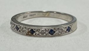 An 18 carat gold mounted sapphire and diamond half eternity ring.
