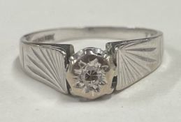 A small diamond single stone ring in 18 carat gold setting.