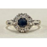 A sapphire and diamond circular cluster ring in 18 carat claw mount.