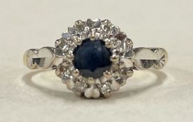A sapphire and diamond circular cluster ring in 18 carat claw mount.