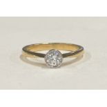 A good diamond single stone ring in 18 carat gold rubover mount.