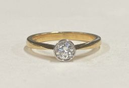 A good diamond single stone ring in 18 carat gold rubover mount.