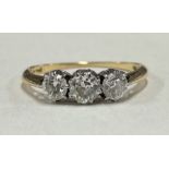 An attractive diamond three stone ring in 18 carat gold and platinum mount.