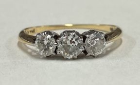 An attractive diamond three stone ring in 18 carat gold and platinum mount.