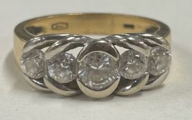 A good diamond five stone half hoop ring in 18 carat two colour gold.