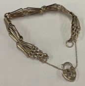 A modern 9 carat gate bracelet with heart shape padlock.