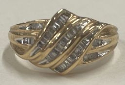 A large 14 carat gold cocktail ring inset with diamonds.