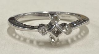 A diamond mounted five stone ring in 9 carat rubover mount.
