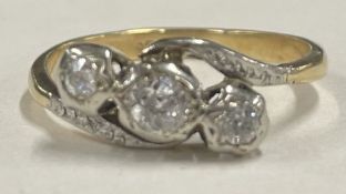 A small diamond three stone crossover ring in 18 carat gold setting.