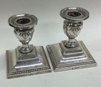A pair of Victorian silver candlesticks with beaded border square. Sheffield 1905.