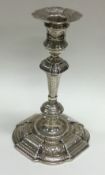 A large early 18th Century George II embossed silver candlestick. London 1731. By Thomas Farren.