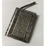A Chinese silver filigree book card case pierced with dragons.