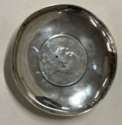 WANG HING: A Chinese silver dish with Chinese emperor coin to centre.