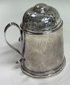 A large 18th Century George II silver kitchen muffineer with handle. London 1730.