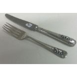 A silver christening knife and fork embossed with bears. By Elkington & Co. Sheffield 1942.