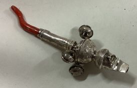 A Georgian silver bright-cut rattle with coral handle.