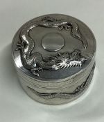 A chased Chinese export silver box embossed with dragons. Marked to base.