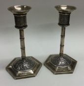 WANG HING: A fine pair of 19th Century Chinese silver candlesticks of bark design. Marked to base.