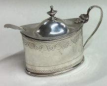 A bright-cut 18th Century George III silver mustard pot and spoon. London 1797.