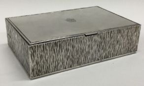 GERALD BENNEY: A fine quality hinged top silver cigarette box with crested decoration.